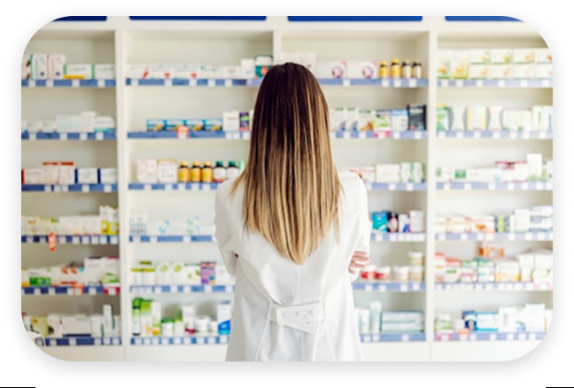Pharmacist reviewing medication shelves